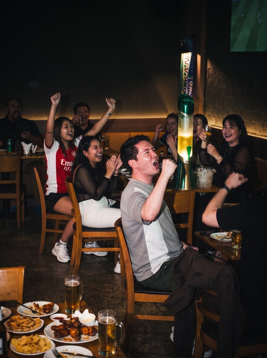 Football fans cheering at The Dark Horse Sports Bar